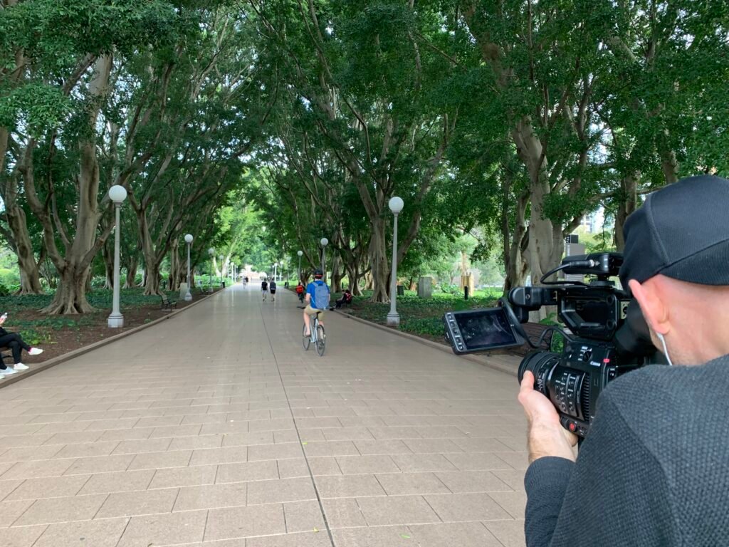 Adam filming at a park
